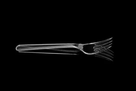 Transparent plastic fork isolated on black background Stock Photos