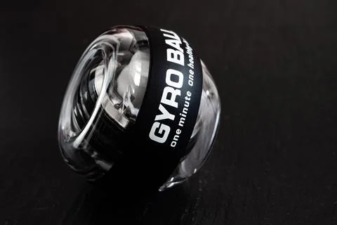 Transparent plastic gyroball on black background. Stock Photos