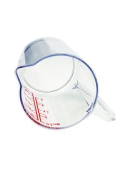 Transparent plastic measuring cup Stock Photos
