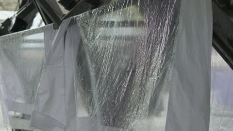 Transparent plastic sheets hanging in slow motion Vídeo Stock 337383760