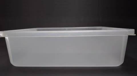 Transparent Plastic Storage Box in square shape, black background. Stock Photos