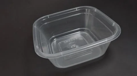 Transparent Plastic Storage Box in square shape, black background. Stock Photos