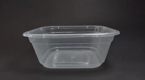 Transparent Plastic Storage Box in square shape, black background. Stock Photos