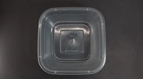 Transparent Plastic Storage Box in square shape, black background. Stock Photos