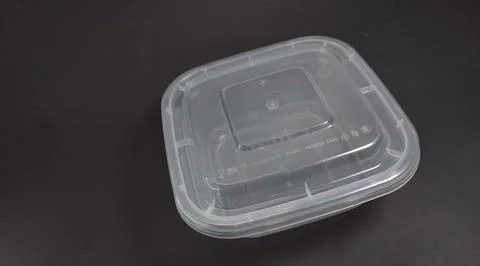 Transparent Plastic Storage Box in square shape, black background. Stock Photos
