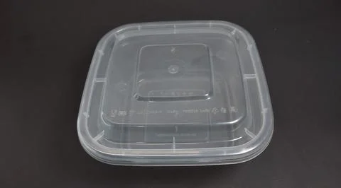 Transparent Plastic Storage Box in square shape, black background. Stock Photos