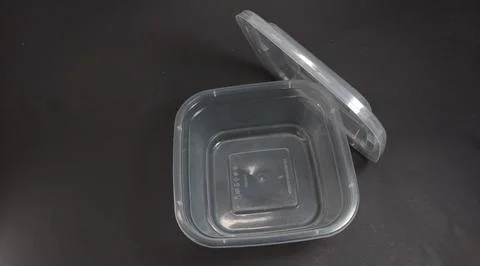 Transparent Plastic Storage Box in square shape, black background. Stock Photos