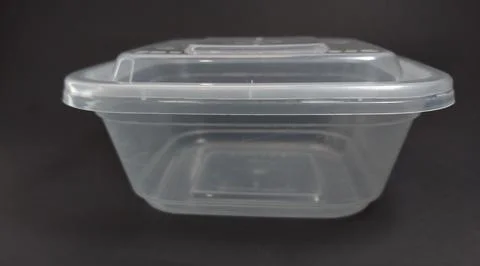 Transparent Plastic Storage Box in square shape, black background. Stock Photos