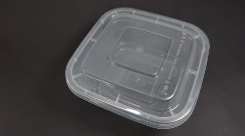 Transparent Plastic Storage Box in square shape, black background. Stock Photos