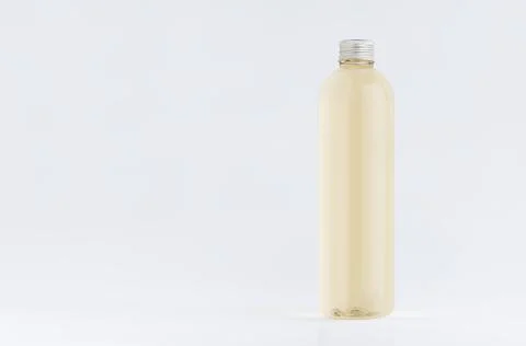 Transparent plastic tall thin bottle with pale fresh drink or cosmetic essent Stock Photos