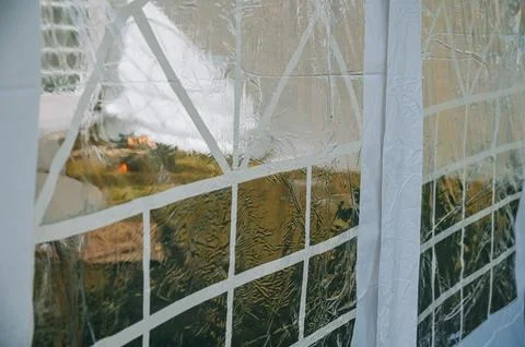 Transparent Plastic Tent Window with Raindrops and Blurred View Stock Photos
