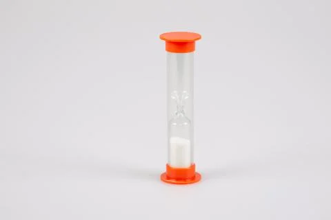 Transparent plastic timer hourglass with white sand for measuring time in gre 스톡 사진
