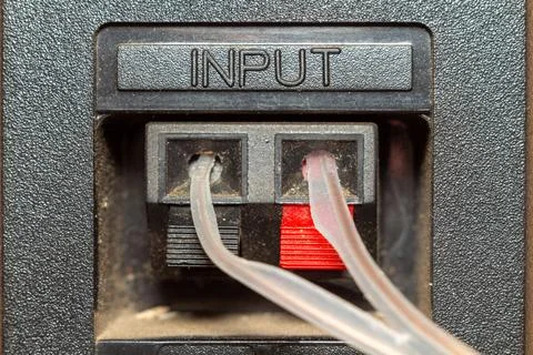 Transparent plastic tubes connected to the input ports of a black industrial 库存照片