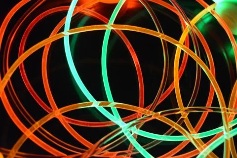 Transparent plastic tubes red, green, yellow, orange, pink backlighting. 스톡 사진