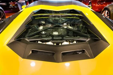 Transparent rear window with engine view of a yellow sports car. Stock Photos