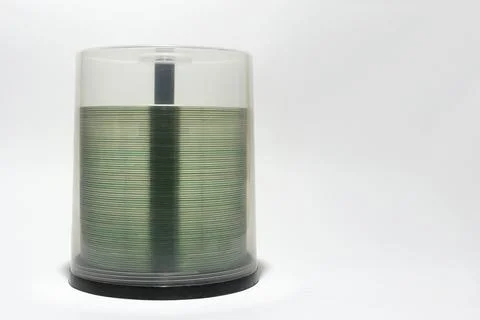 Transparent rim of cds in stack. plastic storage tube with blurry visible s.. Stock Photos