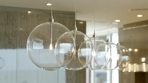 Transparent round lamps in form of balls hanging on suspended ceiling in row Stock Footage 265201631
