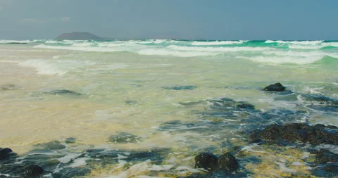 Transparent shallow ocean waves splashing foam. Fuerteventura, Grandes Playas Stock Footage 201856174
