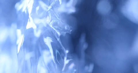 Transparent sheet in blue light Macro shot 스톡 동영상 327346593