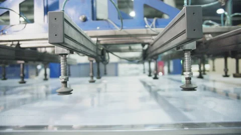 Transparent sheet of polycarbonate moves along conveyor belt Stock Footage 230038523