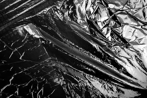 A transparent stretch plastic wrap on black background Stock Photos