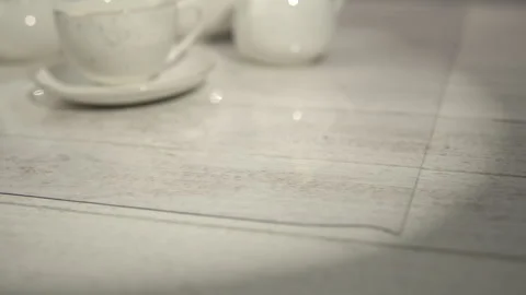 Transparent Tea Set Tray on Light Wood Surface for Elegant Tableware Stock Footage 268116170