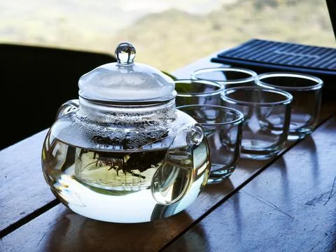 Transparent Teapot and Empty Glasses on a Rustic Wood Table Stock Photos