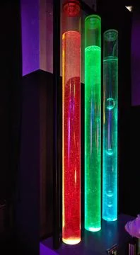 Transparent tubes with multi-colored liquid of different densities for experi Stock Photos