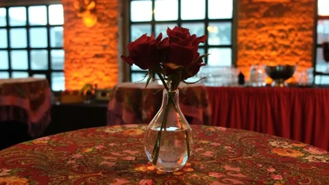 transparent vase with roses is on the table Stock Footage 233511384