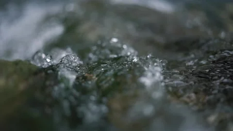 Transparent water with bright sunlight reflections falls Stock Footage 143310636