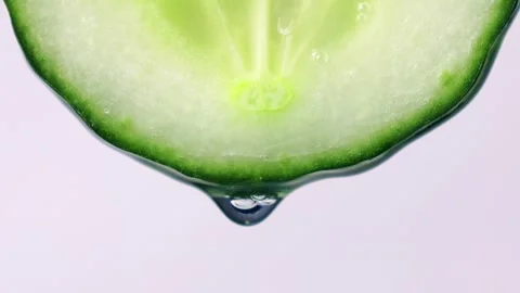 Transparent water drop falling down from bright green cucumber slice 스톡 동영상 270478125