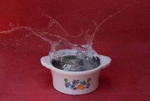 Transparent water splash in the container Stock Photos