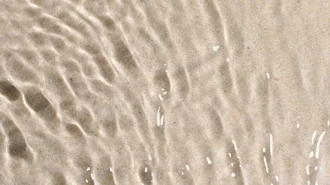 Transparent water surface ripples texture motion, waves, splash, sand background Stock Footage 196904891