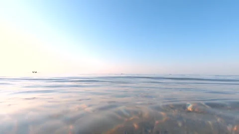 Transparent water surface of sea, waves, ripples on water close-up, sandy bottom Stock Footage 241435868
