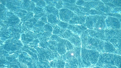 Transparent waves are moving almly in swimming pool on sunny day in summer Stock Footage 141241683