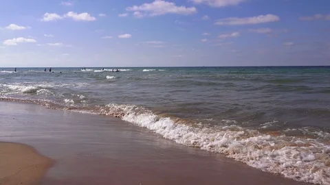 Transparent waves roll on a sandy beach Video stock 93374847