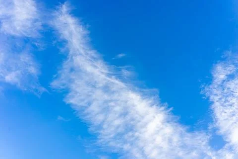 Transparent white clouds on the background of the blue sky Stock Photos