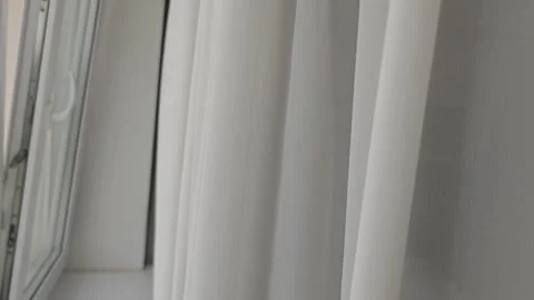 Transparent white curtain on the window, gently moved by the wind. Peaceful Stock Footage 345875026