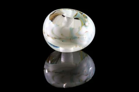 Transparent white glassy bead with reflection Foto stock