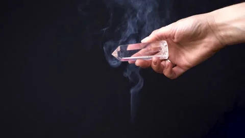 Transparent white quartz crystal cleansing with the smoke of palo santo. Stock Footage