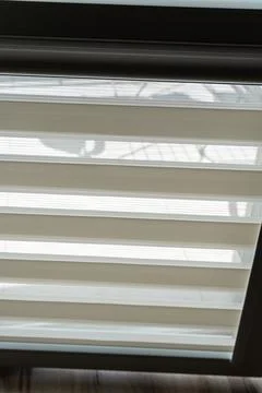 Transparent window blinds casting shadows indoors, creating a soft and elegant Stock Photos
