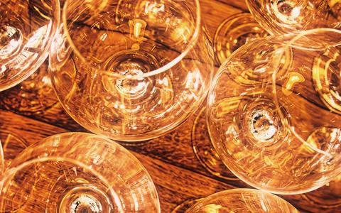 Transparent Wine Glasses Arranged on Rustic Wooden Surface Reflecting Warm .. Fotos Stock