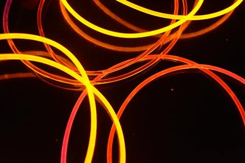 Transparent wire, polyethylene tubes, rods with red, pink, orange, yellow. 스톡 사진