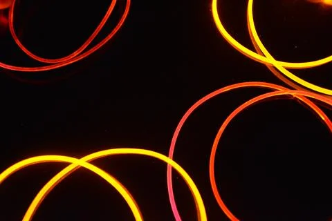 Transparent wire, polyethylene tubes, rods with red, pink, orange, yellow. 스톡 사진