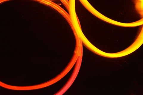 Transparent wire, polyethylene tubes, rods with red, pink, orange, yellow. 스톡 사진