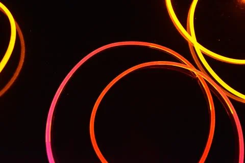 Transparent wire, polyethylene tubes, rods with red, pink, orange, yellow. 스톡 사진