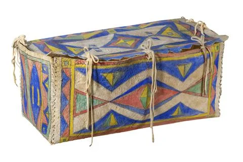 Transport box made of rawhide painted Indian with leather cords painted on white Stock Photos