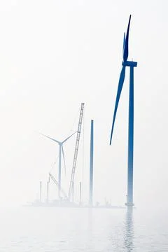 A transport ship and crane for constructing an offshore windpark Stock Photos