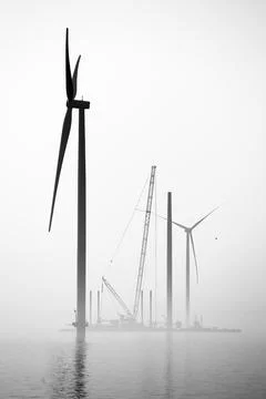 A transport ship and crane for constructing an offshore windpark Stock Photos