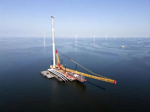 A transport ship and crane for constructing an offshore windpark Stock Photos